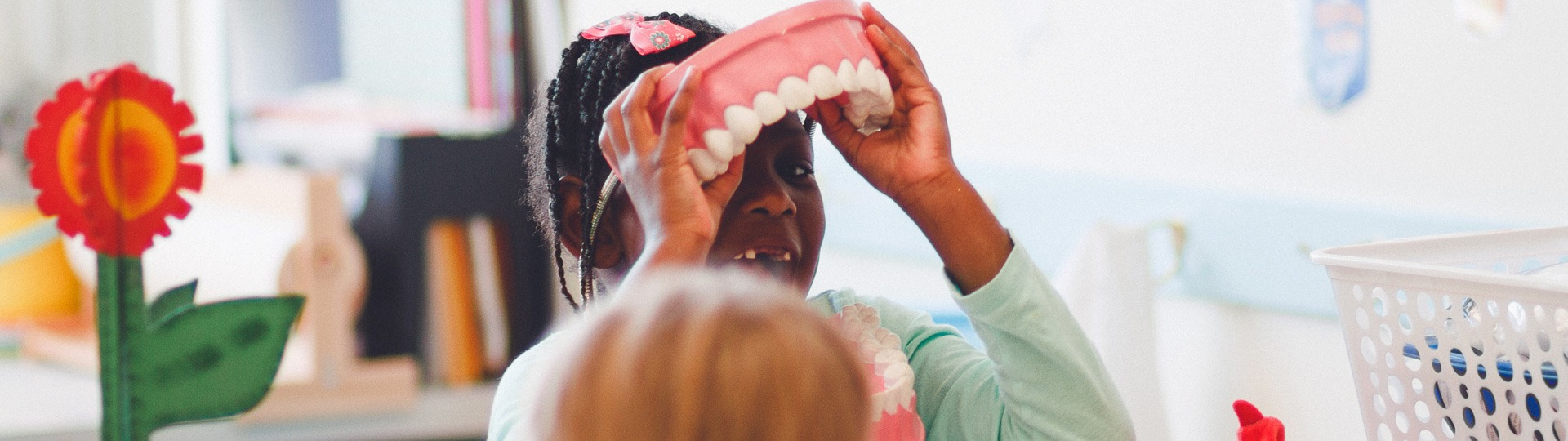 Girl wearing giant teeth for fun